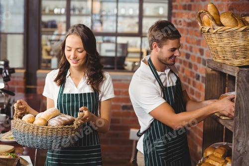 Preview: Happy co-workers working with a smile at the coffee shop