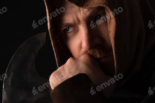 Preview: pensive medieval Scottish warrior with battle axe isolated on black