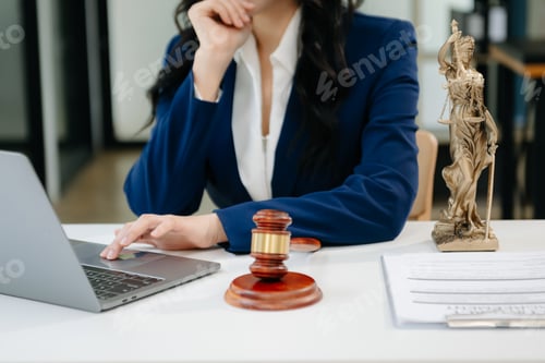 Preview: Female lawyer in the office with brass scale on wooden table. justice and law concept
