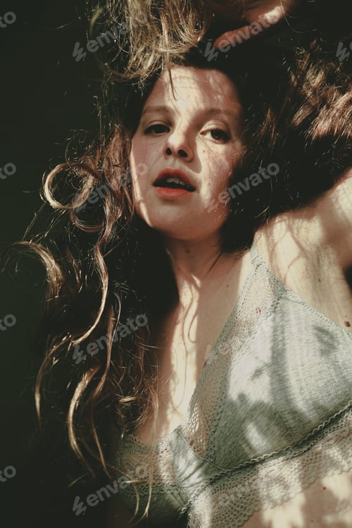 Preview: Body positive portrait of a young woman with light and shadows