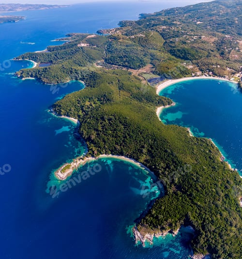 Preview: Aerial view of green coastline and clear blue waters.