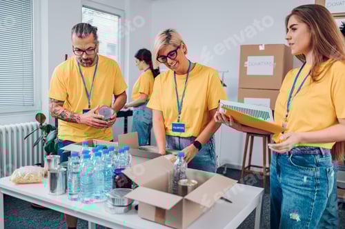 Preview: Group of multiracial volunteers working in community charity donation center