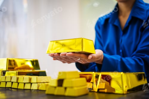 Preview: An Asian business woman sitting at her desk in office,analyzing gold bullion prices,market trends