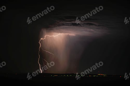 Preview: Lightning and storm clouds over the sea and the city.