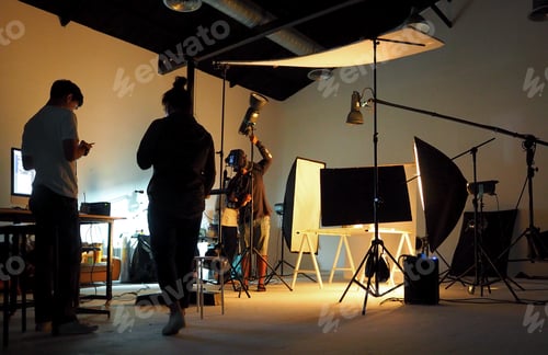 Preview: Silhouette of people working in production studio.