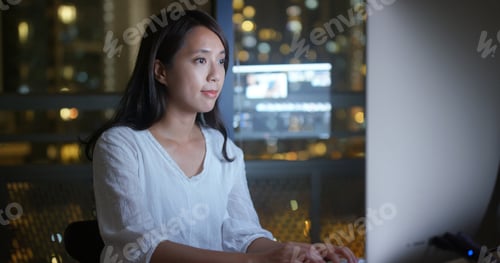 Preview: Woman work on computer at night