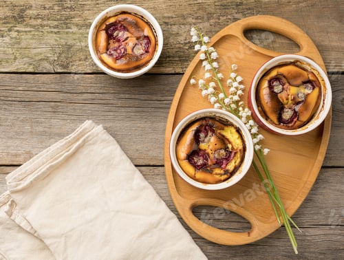 Preview: Cottage cheese dessert baked in portioned round ceramic plates on a wooden table