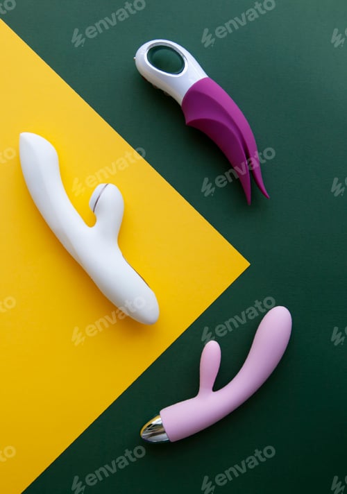 Preview: Collection of different types of sex toys on a green and yellow background.