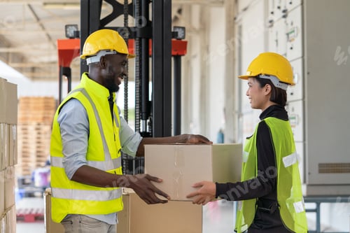 Preview: Asian woman and black man worker holding cardboard box preparing product for shipment at warehouse