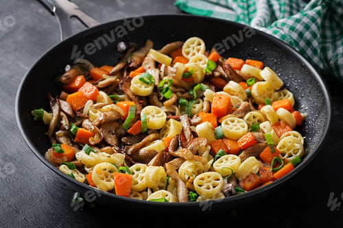 Preview: Rotelle pasta gluten free with mushrooms and pumpkin on a dark background.