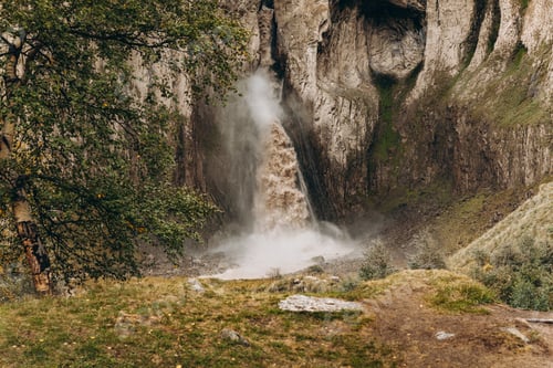Preview: A high, stormy waterfall flowing down the massive rocks of Djily-su. A journey through the mountain