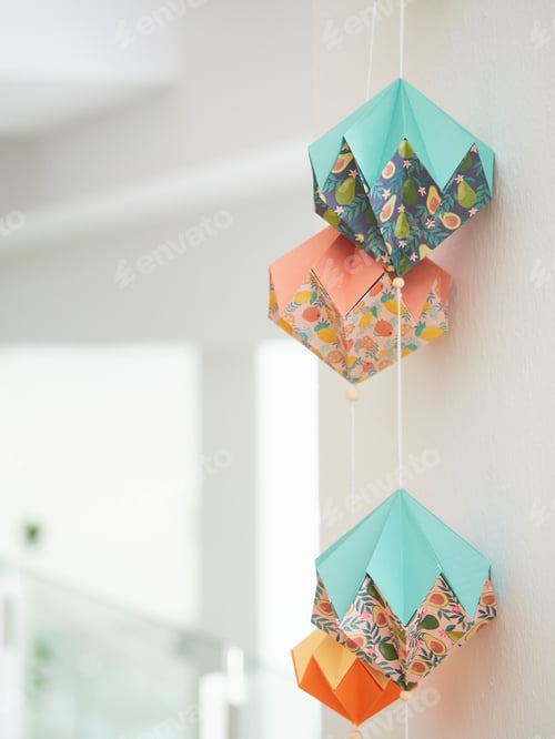 Preview: origami garland hanging on the wall, abstract geometric decoration with paper