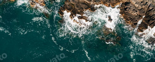 Preview: Aerial view of a blue beach with beautiful rocks.