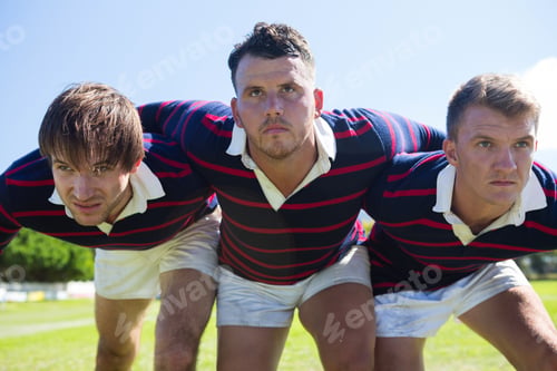 Preview: Close up of rugby players bending while standing at field