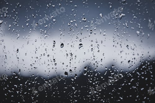 Preview: Wet window in rainy autumn weather. water drops on glass, blue toned