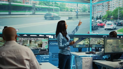 Preview: Indian supervisor assigning tasks for her operators team in observation room
