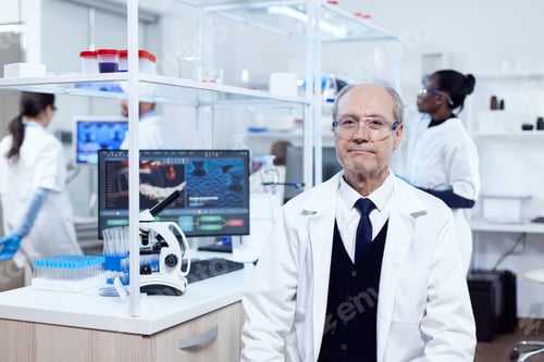 Preview: Senior man with virus on computer display looking at camera