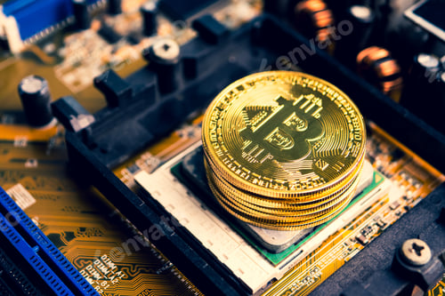 Preview: Stack of golden coins with bitcoin symbol on a mainboard.