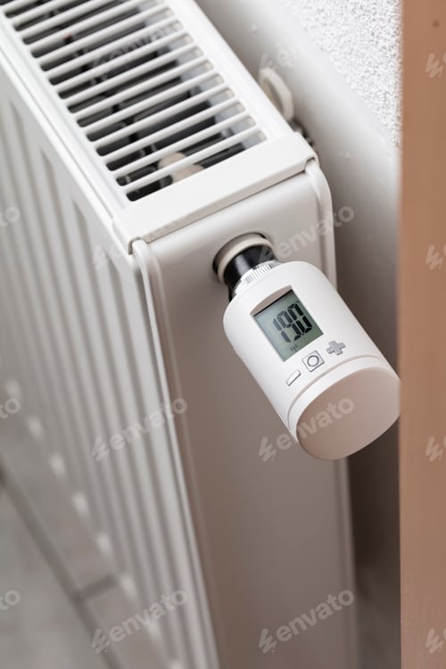 White Radiator with Digital Thermostat Inside a Home