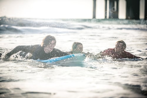 Preview: Three surfers practicing in the ocean