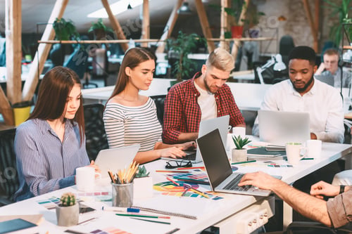 Preview: Young Professionals Collaborate in Modern Office Workspace During Daytime