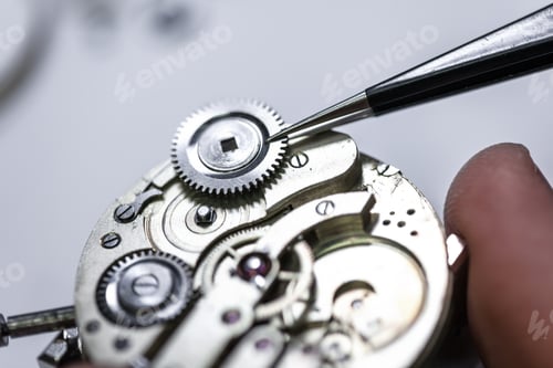 Preview: Closeup shot of a craftsman fixing gears on a clock