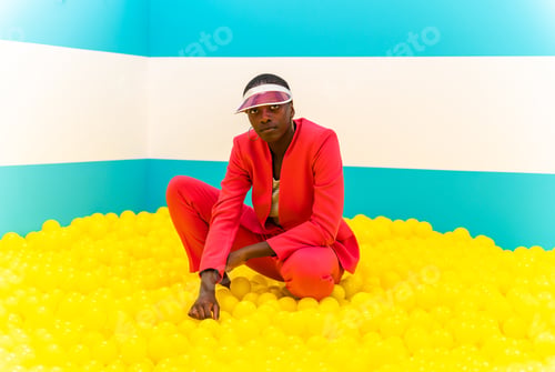 Preview: Beautiful young woman posing and having fun inside a rainbow box room