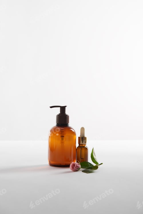 Preview: Cosmetic containers and rose flower on white surface