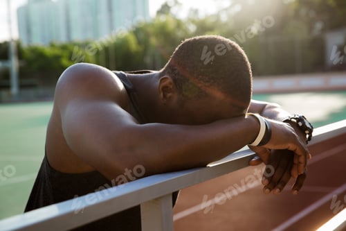 Preview: Close up of a african sportsman leaning on the railing