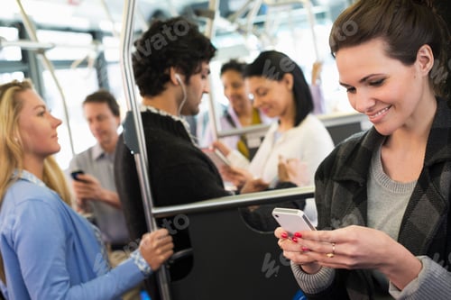 Preview: People on a New York city bus. A young woman checking or using her cell phone.