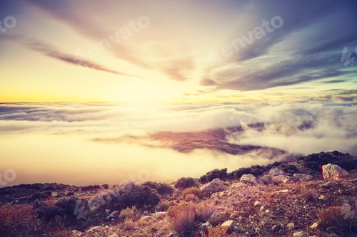Preview: Color toned scenic mountain sunset above the clouds, USA