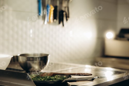 Preview: Cooking greens in pan on kitchen stove