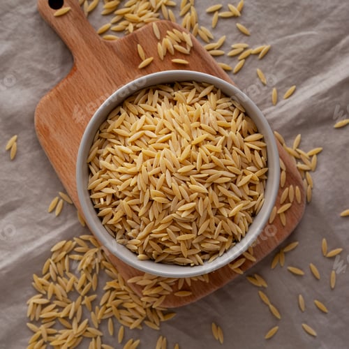 Preview: Organic Dried Orzo Pasta in a Bowl, top view. Close-up.