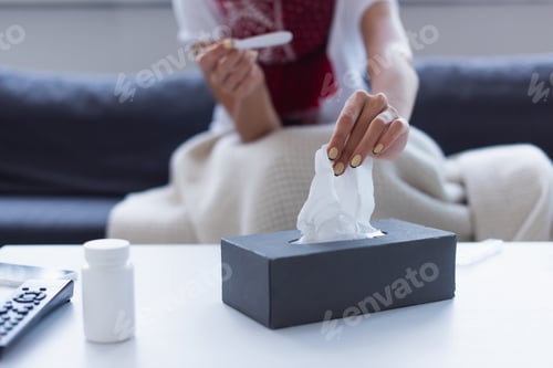 Preview: cropped view of blurred woman with thermometer taking paper napkin from pack
