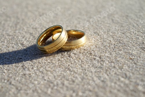 Preview: Wedding rings at the beach with copy space
