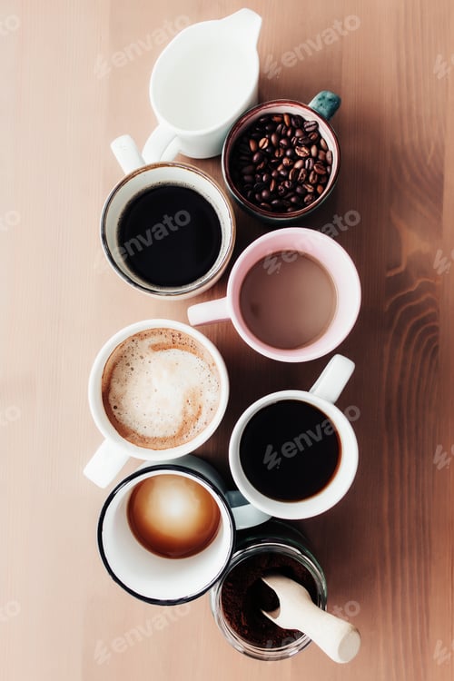 Preview: Multiple coffee cups, milk, beans and ground coffee in jar on wooden background