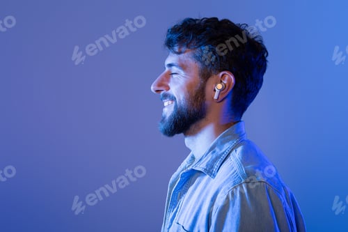 Preview: Man With Beard Wearing Ear Buds, Side View