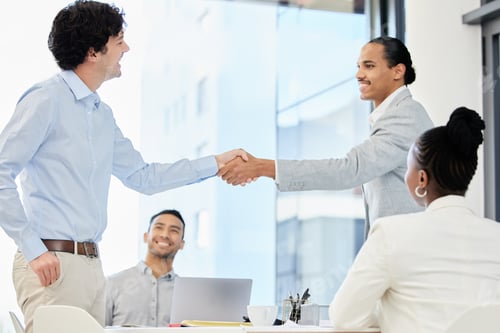 Preview: Shot of a group of people having a meeting and shaking hands in a modern office