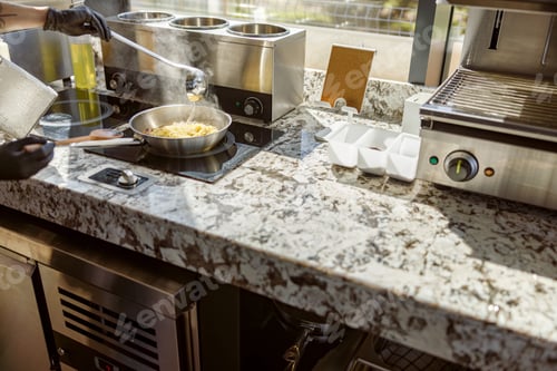 Preview: Cooking in a Modern Kitchen that Features a Beautiful Granite Countertop Surface