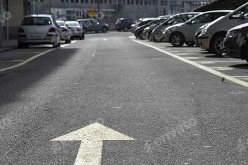 Preview: Arrow road sign (marking on the ground) with big negative space within the blurry background