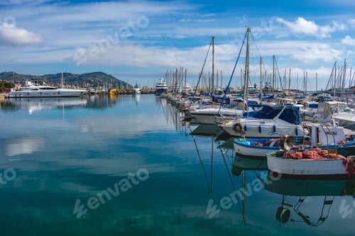 Preview: Sailing boat in the port with a cloudy blue sky
