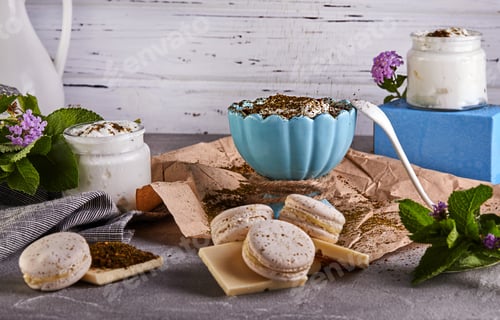 Preview: Wooden cutting board topped with macarons , chocolate , yogurt and grapes