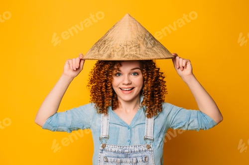 Preview: Smiling Woman with Curly Hair Wearing Conical Hat