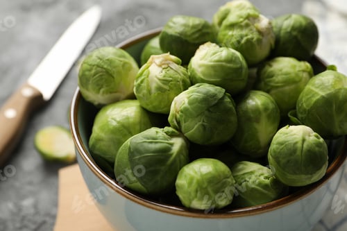 Preview: Composition with bowl of brussels sprout on grey background, close up