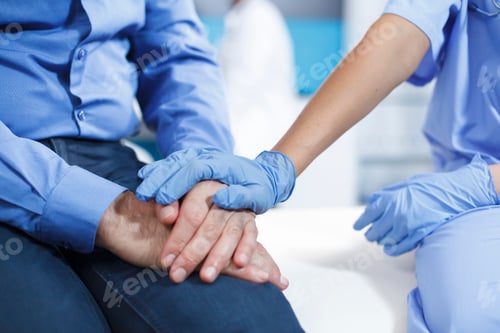 Preview: Medical Professional Comforts Patient with Hand on Hand
