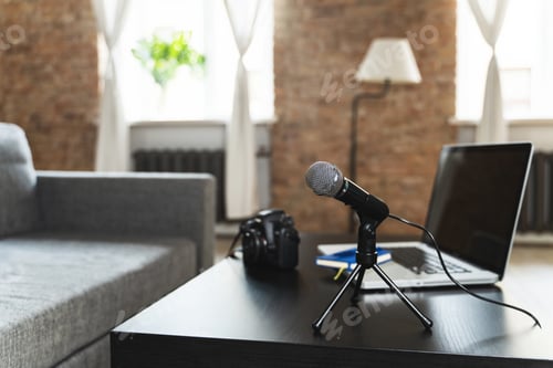 Preview: Laptop, camera, microphone, and notebook on a journalist's work desk