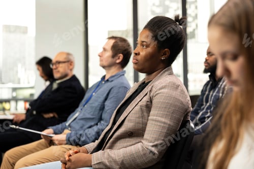 Preview: African american female attending professional summit in conference room