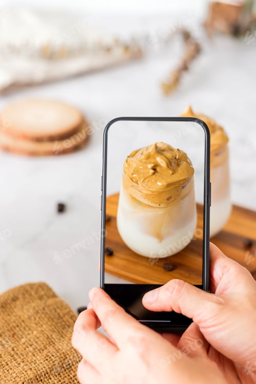 Preview: Dalgona coffee with fluffy cream served on wood tray.Homemade trendy beverage menu on social media