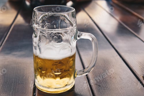 Preview: Beer jar on wooden table. Close up shot with space for copy
