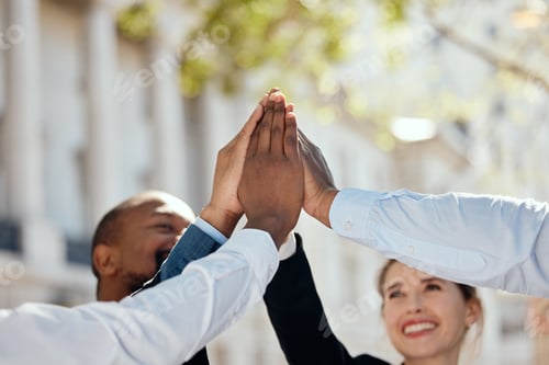 Preview: Shot of a group of businesspeople giving each other a high five in the city